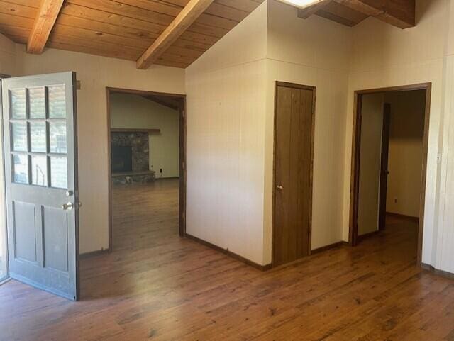 hall with lofted ceiling with beams, wooden ceiling, and dark wood-type flooring