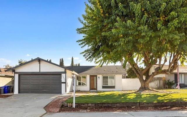 ranch-style house featuring a front yard and a garage