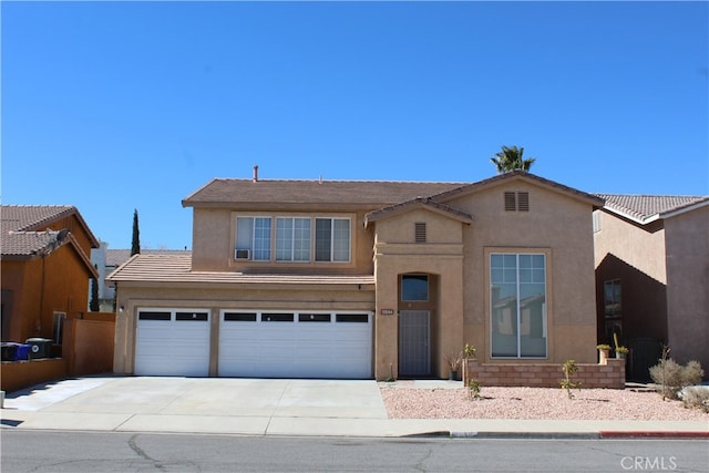 view of front of home with driveway, an attached garage, and stucco siding