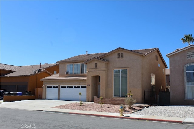 view of front facade with a garage, driveway, and stucco siding