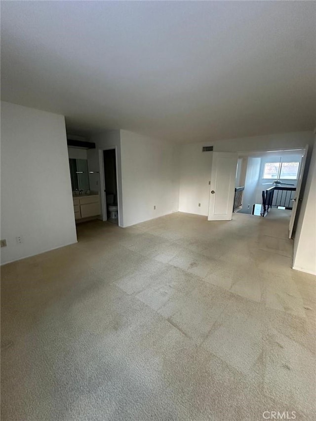 unfurnished living room featuring light colored carpet