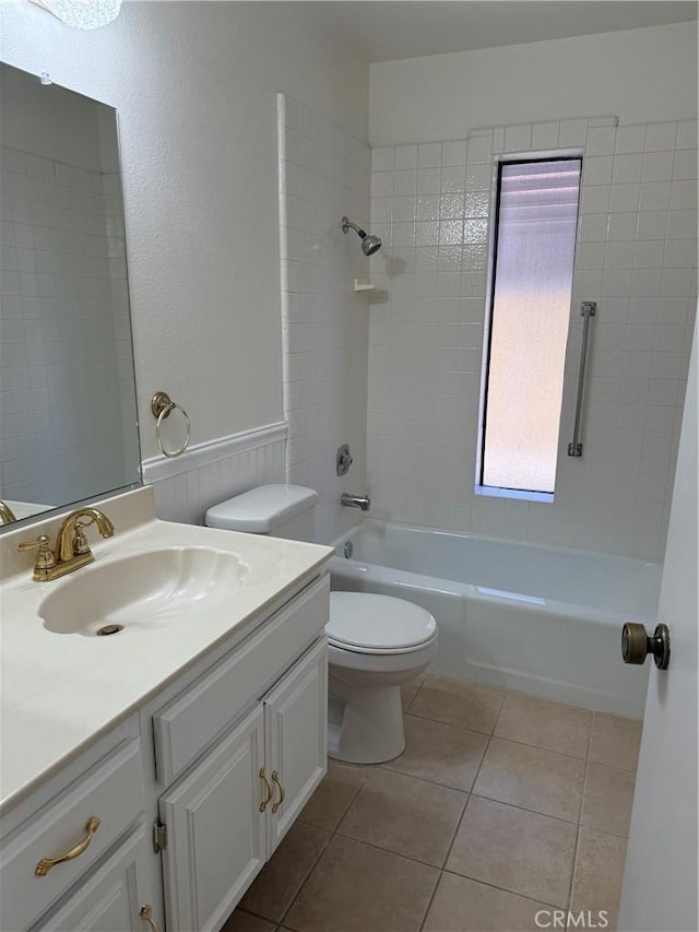 full bathroom featuring toilet, vanity, tile patterned floors, and tiled shower / bath