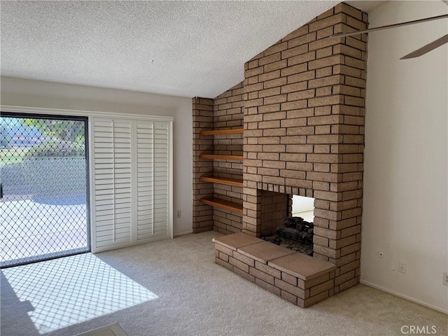 unfurnished living room with lofted ceiling, light colored carpet, a textured ceiling, and a brick fireplace