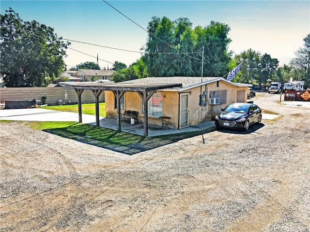 view of front facade with a patio and cooling unit