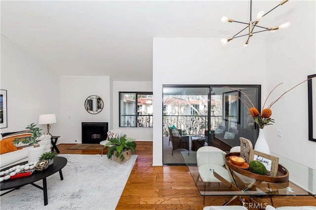 living room featuring an inviting chandelier and hardwood / wood-style flooring