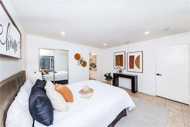 bedroom featuring a closet and light tile patterned floors