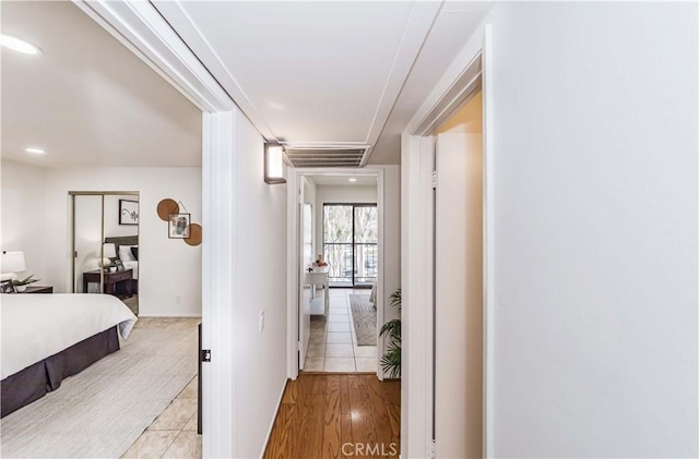 hallway with light hardwood / wood-style floors