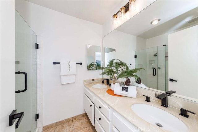 bathroom with tile patterned floors, walk in shower, and vanity