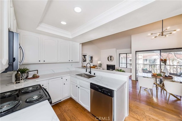 kitchen featuring sink, white cabinetry, stainless steel dishwasher, and kitchen peninsula