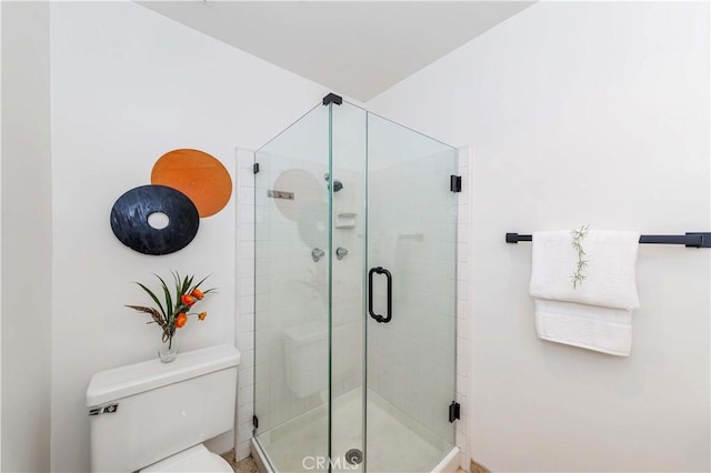 bathroom featuring toilet and walk in shower