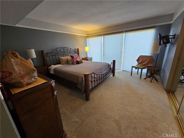 carpeted bedroom featuring a textured ceiling