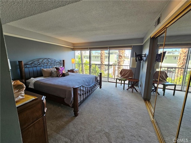 carpeted bedroom featuring a textured ceiling