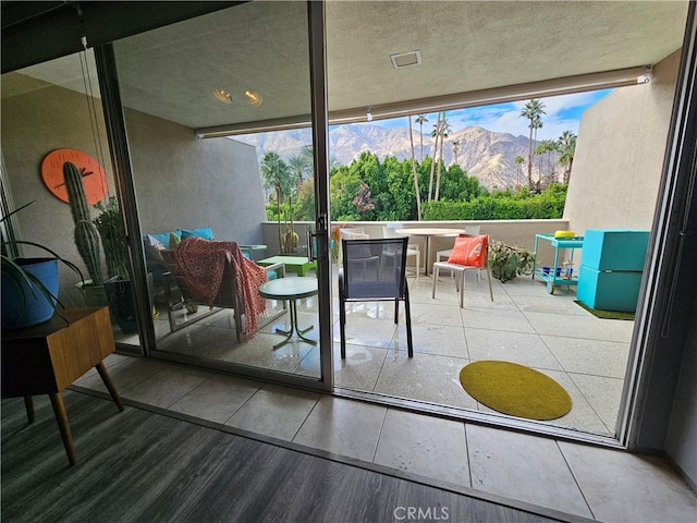 balcony with exterior bar and a mountain view