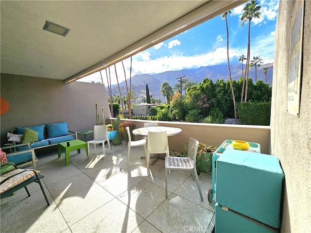 balcony with a mountain view and an outdoor living space