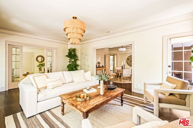 living room featuring dark hardwood / wood-style flooring and ornamental molding