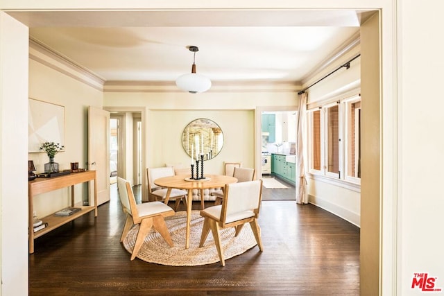 dining space with dark hardwood / wood-style flooring and ornamental molding