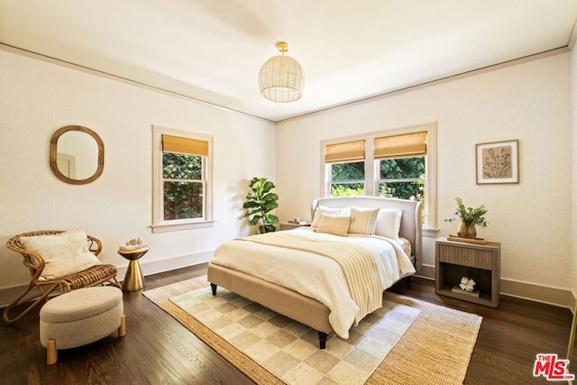 bedroom featuring dark hardwood / wood-style flooring and crown molding