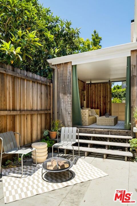 view of patio / terrace with an outdoor living space with a fire pit