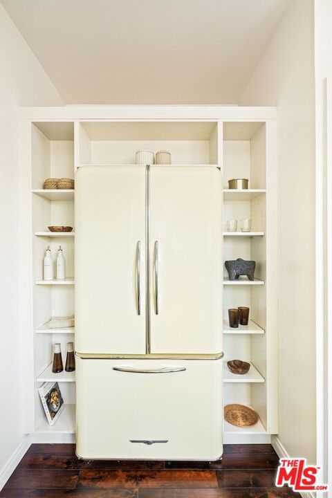 room details featuring dark hardwood / wood-style flooring and white fridge