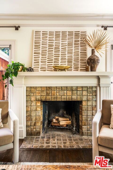 details with hardwood / wood-style floors and a tile fireplace