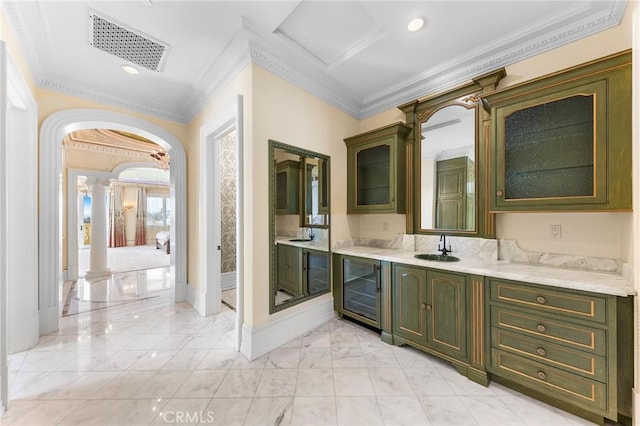 bathroom with vanity, ornamental molding, wine cooler, and decorative columns