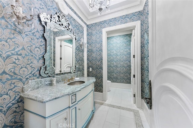 bathroom with vanity, crown molding, tile patterned flooring, toilet, and a notable chandelier