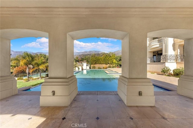 view of patio / terrace featuring a mountain view and a fenced in pool