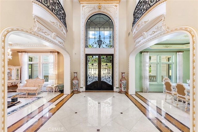 foyer featuring french doors and a high ceiling