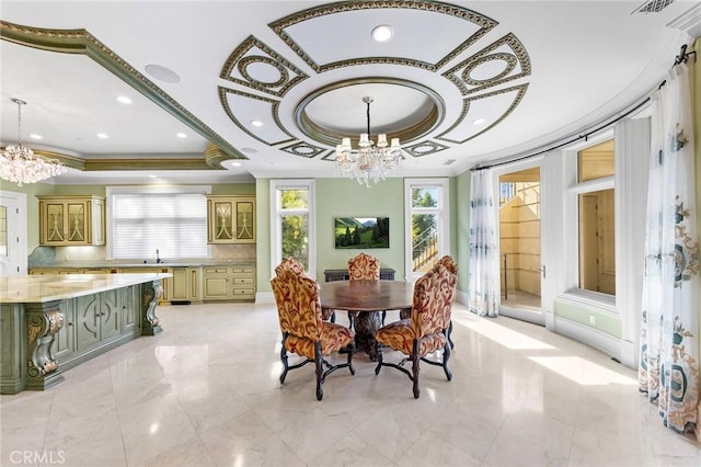 dining room with a tray ceiling, an inviting chandelier, and sink