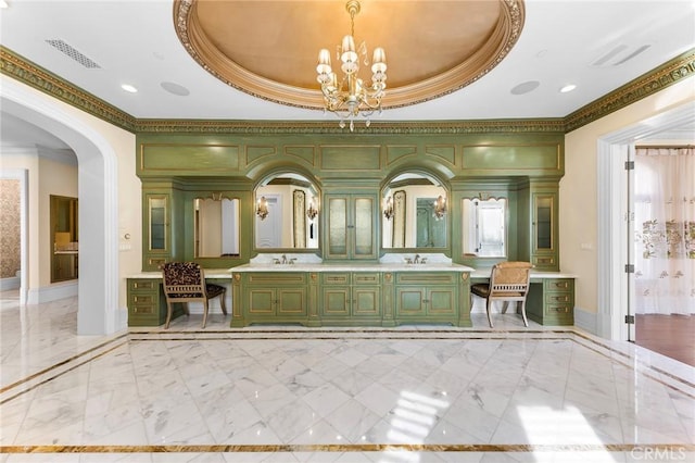 bathroom with vanity, a tray ceiling, crown molding, and a notable chandelier