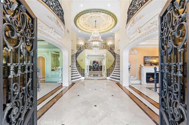 entrance foyer with a towering ceiling and ornamental molding