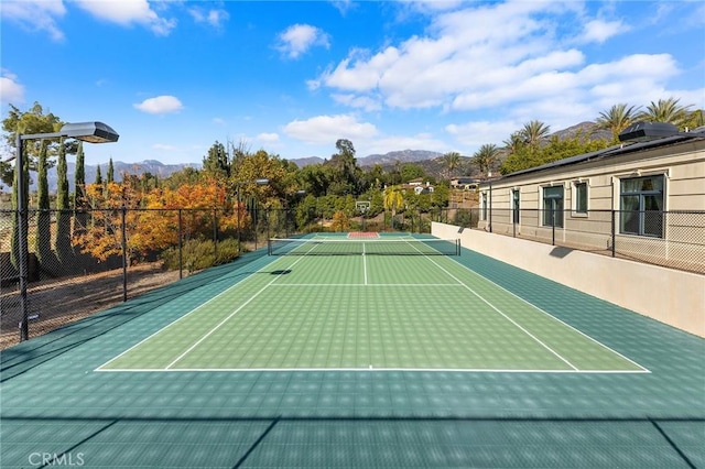 view of tennis court with a mountain view and basketball court