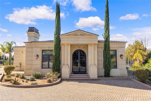 view of exterior entry featuring french doors