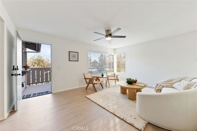 81 Smokestone Unit 12, Irvine, CA 92614 - living area with light wood-type flooring, ceiling fan, and baseboards
