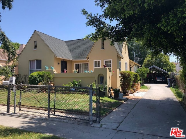 view of front of house with a front yard and a carport