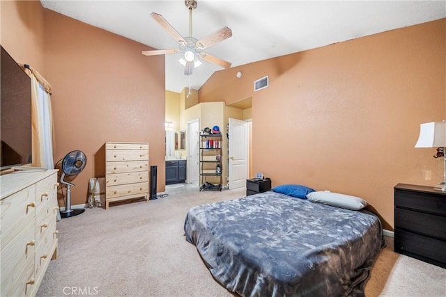 carpeted bedroom featuring ceiling fan, high vaulted ceiling, and ensuite bathroom