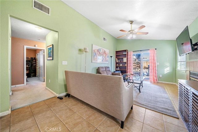 tiled living room with ceiling fan and vaulted ceiling