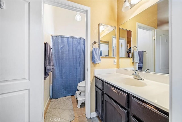 bathroom with tile patterned flooring, vanity, toilet, and a shower with shower curtain