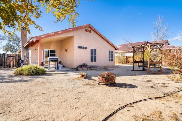 back of property featuring a fire pit