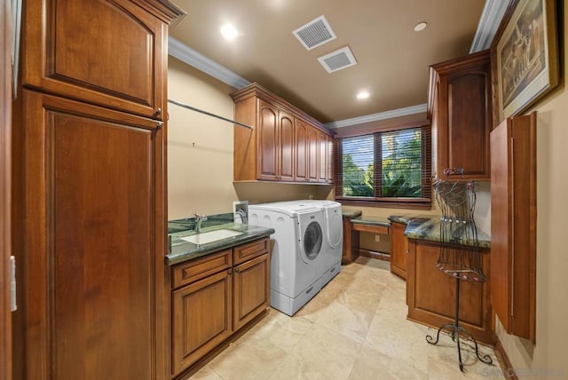 washroom with washer and clothes dryer, sink, cabinets, and crown molding