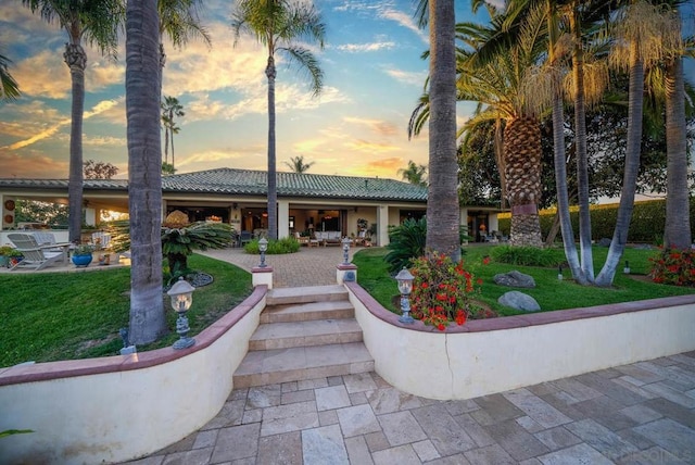 view of community with a lawn and a patio