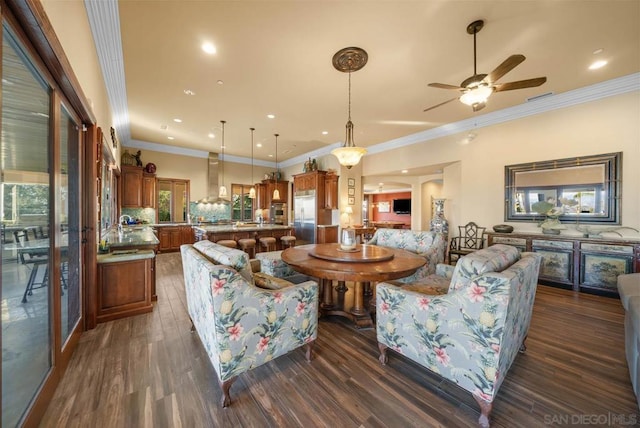 living room with ceiling fan, sink, ornamental molding, and dark wood-type flooring