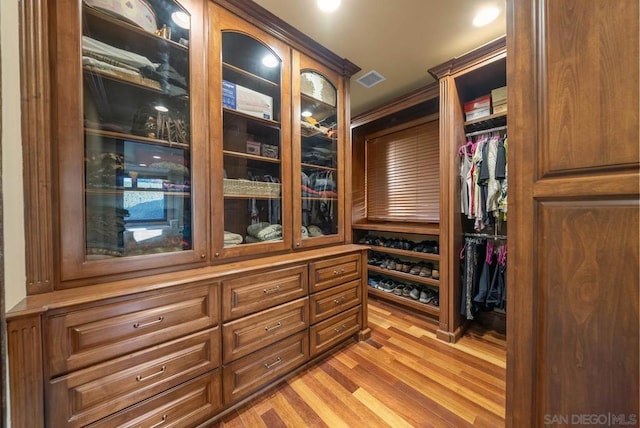 walk in closet featuring light hardwood / wood-style flooring