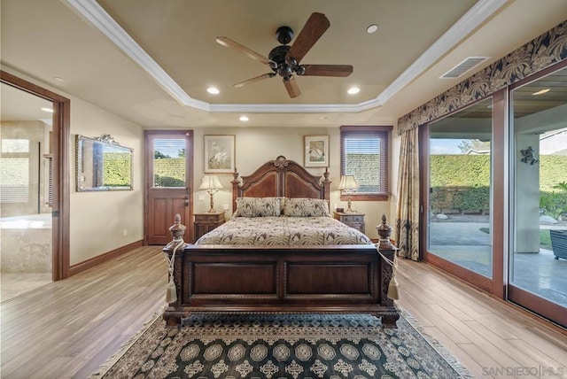 bedroom with ceiling fan, crown molding, a tray ceiling, multiple windows, and access to outside