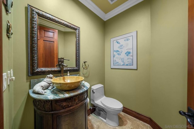 bathroom featuring tile patterned flooring, vanity, toilet, and ornamental molding