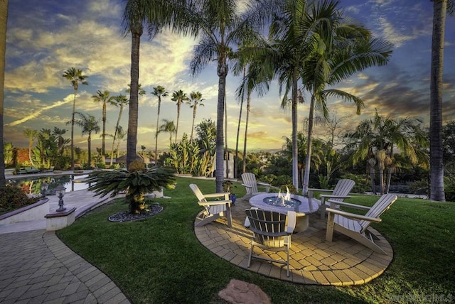 yard at dusk with a patio and a swimming pool