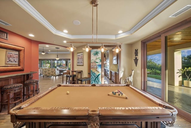 playroom with light hardwood / wood-style floors, a raised ceiling, ornamental molding, and pool table