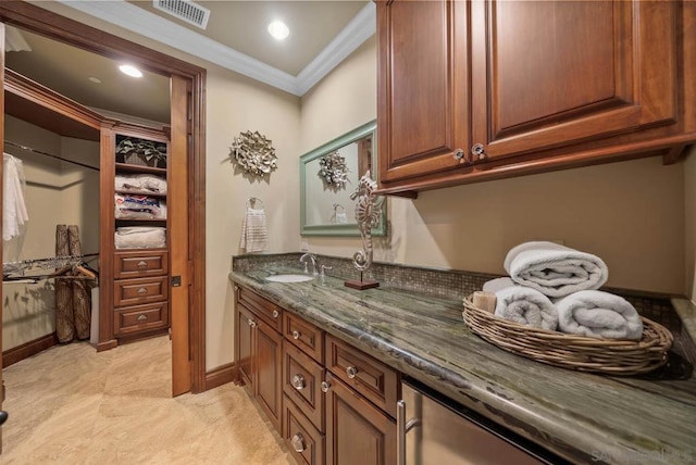 interior space featuring vanity and crown molding