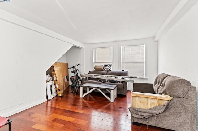 sitting room with lofted ceiling and dark wood-type flooring