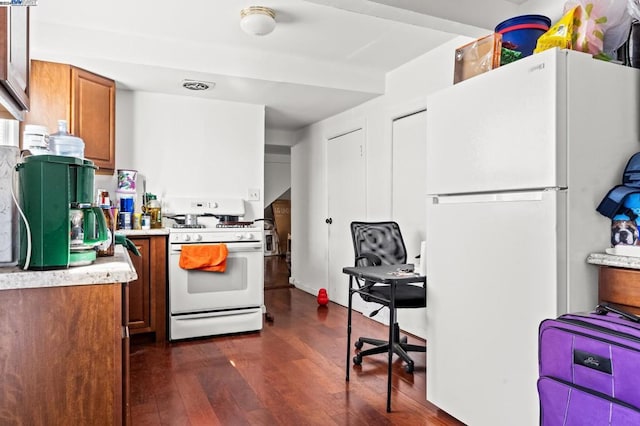 kitchen with white appliances and dark wood-type flooring